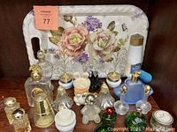 Photo of the floral serving tray with handles and the Avon collectible bottles arranged on a surface.
