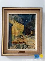Framed print titled 'Cafe Le Soir' depicting an outdoor cafe night scene with starry sky, warm yellow and dark blue tones.