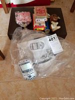 Top down view of the electronic Texas Hold 'Em game with packaging and other items including decks of cards, tarot cards, kaleidoscope, leather mouse