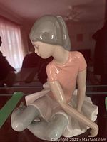 Front and side views of the delicate porcelain ballerina figurine showing detailed facial features and costume colors.