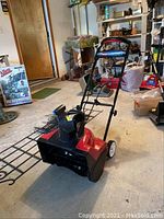 Front angle view of the Toro Power Curve snow blower showing the handlebar, chute, and body.