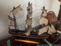 Overall view of the Velero Español 1768 wooden ship model with fabric sails and rigging mounted on wooden base.