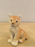 Front view of the ceramic cat figurine showing detailed facial features and coloration.