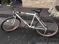 Side view of white Auto Pro oversized 15-gear bicycle showing frame, wheels, seat, and handlebars with rust visible.