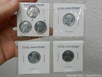 Six steel war pennies mounted in white cardboard holders labeled 'Steel War Penny' with visible mint marks 'D', 'P', and 'S'.