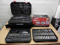 Overview of closed case, open trays laid out and original box packaging