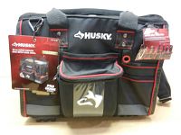 Front view of the black and gray Husky tool bag with labels showing product details.