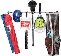 Sports storage rack demonstrating usage with various sports equipment hanging including balls, helmets, racquets, bats, and bags.
