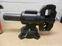Bessey vise close-up showing rotating swivel base, pipe jaws and handle.
