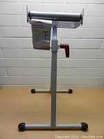 Full view of HDX ball bearing roller stand showing adjustable height and black roller on stable metal frame.