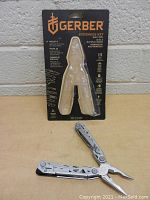 Photo showing the Gerber Suspensio NXT multi-tool in original packaging, showcasing the 15 tools included.