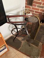 Full view of cast iron stand with wooden arms and sharpening wheel