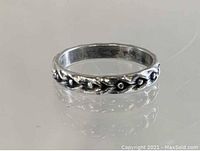 Close-up photo of the antique sterling silver ring displaying the wheat berry pattern around the band.