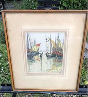 Full view of the framed lithograph depicting Dutch sailing barges in harbor with visible discoloration on mat.