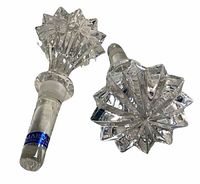 Close-up photo of one crystal Marquis Waterford bottle stopper showing starburst top and stopper base with label.