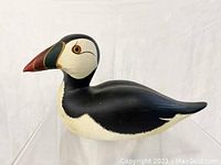 Front and side view of the wooden common puffin decoy showing detailed paint and form.