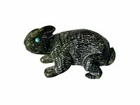 Top and side views of a small dark green stone jack rabbit figurine with detailed fur texture and turquoise inlaid eyes.