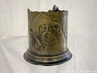 Front view showing the detailed relief of a bearded Viking warrior in helmet and nose guard, along with part of the crenelated rim.
