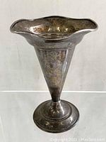 Full view of the flared top, cone-shaped sterling silver vase with ripple edge rim and weighted base.