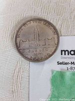 Obverse side of the 1939 Canadian silver dollar coin showing Parliament buildings and inscriptions.