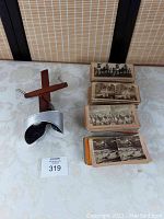 Wooden and metal vintage Sun Sculpture stereoscope 3D viewer alongside stacks of stereoscopic viewing cards.