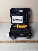 DeWalt DW660 cut-out tool coiled cord inside molded black carrying case with instruction manual.