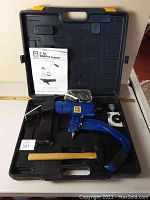 Complete Power Fist 2" Air Flooring Stapler kit including stapler, case, manual, goggles, magazines, and mallet.