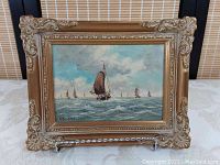 Front view of oil painting on board signed by A. Martens with ornate gold frame.