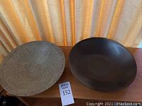 Top view of two ceramic bowls side by side: the left bowl has a speckled textured surface, the right bowl is smooth and dark.
