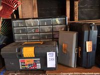 Photo of a heavy duty plastic toolbox with a yellow latch, a large plastic hardware organizer with multiple clear small drawers holding hardware items, and two additional tool cases