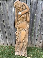 Full view of the vintage copper relief wall sculpture depicting a woman holding a jug in flowing dress and headwrap, approximately 5 feet tall.