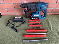 Full kit overview: hammer, battery, charger, handle and attachments displayed