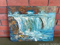 Full view of the vintage oil painting on board depicting a waterfall with natural surroundings, painted with thick brush strokes.