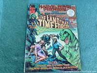 Front cover of the 1975 Marvel Movie Premiere comic The Land That Time Forgot with full colorful photo and text.