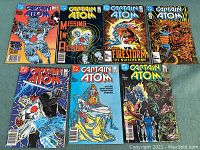 Seven Captain Atom comics from 1987, Vol. 2, issues 3 through 9, laid out on blue surface showing colorful cover art.