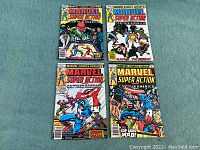 Four Marvel Super Action comic books arranged on blue carpet. Covers feature Captain America and other characters with vibrant 1970s style cover art.