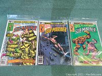 Three Marvel comic books from the series Tales to Astonish starring The Sub-Mariner, issues 3, 7 and 8, displayed side by side in plastic protective sleeves.