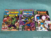 Three vintage Marvel comics featuring The Thing, Hulk, Giant-Man, and Aquarian. Visible cover art and slight wear on edges.