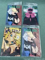 Four Black Kiss comics in polybags, issues 6 (two copies), 7, and 10, arranged flat showing front covers.