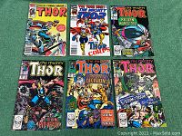 Full set of six vintage Marvel Thor comic books, showing front covers with various titles and artwork featuring Thor in action.