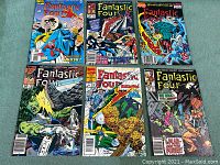 Six vintage Fantastic Four Marvel comic books arranged in two rows of three on a white surface. Shows front covers featuring colorful artwork.
