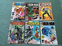 Six Marvel Iron Man comic books laid out flat, showing cover art and issue numbers 187, 189, 191, 193, 194, 198.