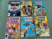 Six Marvel Comics Iron Man comic books arranged flat on green surface, showing front covers, issues No. 199, 203, 206, 207, 208, 209.