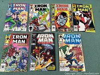 Seven Iron Man comic books laid out in two rows showing covers of issues 210, 211, 212, 213, 214, 215, and 229.