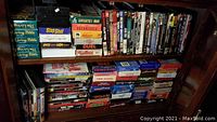 Shelf with DVDs and VHS tapes, various movie and TV show titles visible including multiple Living Bible VHS tapes, other VHS cases like Slap Shot and Dreamlover.
