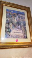 Full view of ornately framed art print showing garden scene with child and dog.