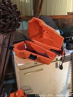 Open orange plastic carrying case interior