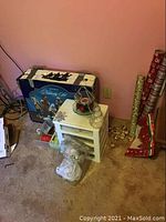 Nativity scene box, angel statue, some bells, bows, and cards visible by wall