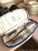 Full set of three pieces in blue velvet-lined case with satin interior showing G & H guaranteed cutlery logo