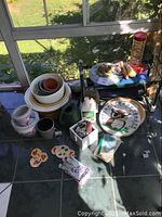 Overview photo showing all items including flowerpots, thermometer, garden stones, watering can, feeder, and seat.